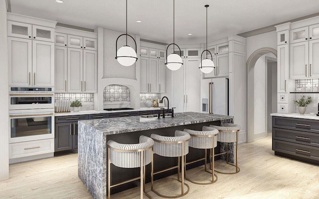 kitchen with tasteful backsplash, black stovetop, stainless steel fridge with ice dispenser, white double oven, and a sink