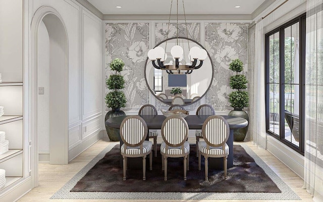 dining space featuring wallpapered walls, a chandelier, and light wood-style floors