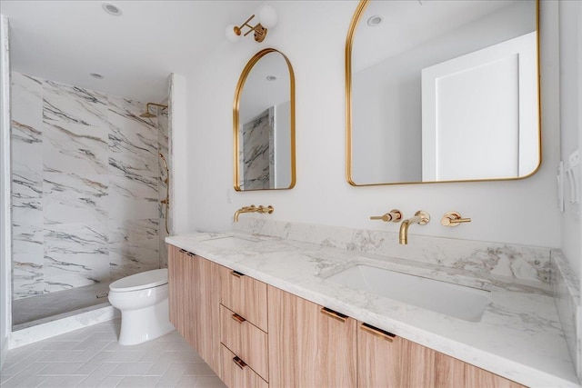 418 Monroe St Unit 201, Hoboken, NJ 07030 - bathroom featuring toilet, double vanity, a marble finish shower, tile patterned flooring, and recessed lighting