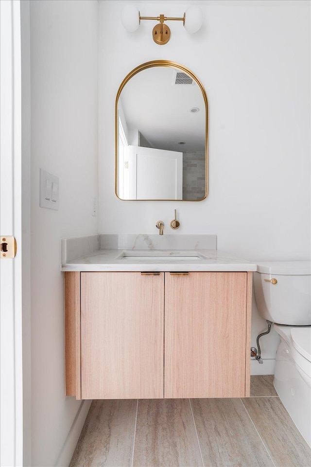 418 Monroe St Unit 201, Hoboken, NJ 07030 - bathroom with vanity, toilet, and wood finished floors
