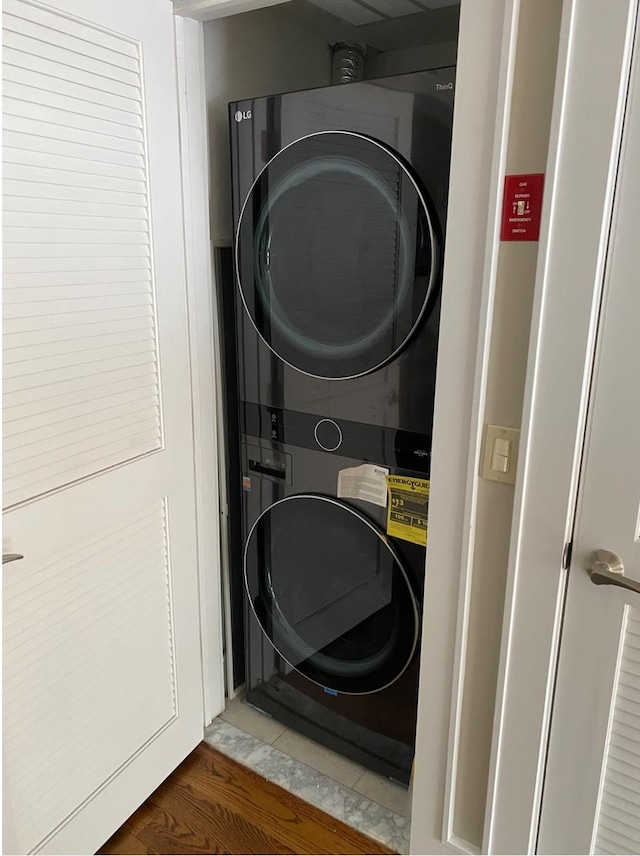 635 6th St Unit 2C, Hoboken, NJ 07030 - laundry area featuring stacked washer / dryer and wood finished floors