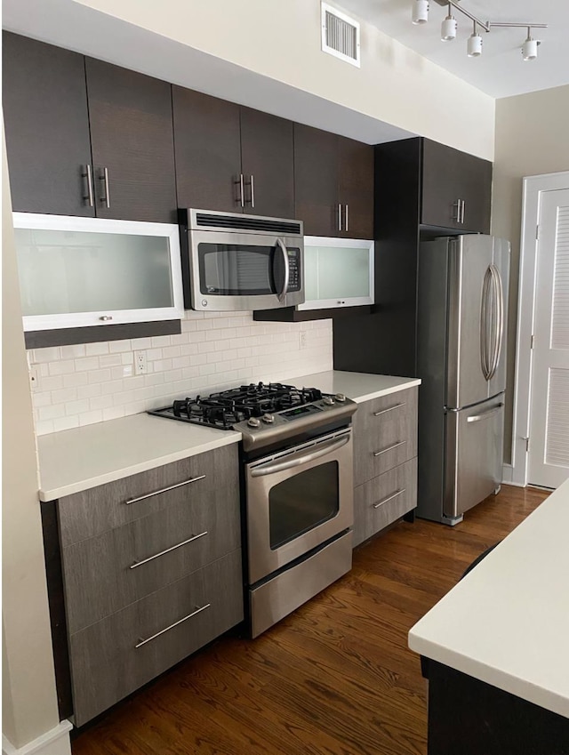 635 6th St Unit 2C, Hoboken, NJ 07030 - kitchen featuring stainless steel appliances, dark wood-style floors, decorative backsplash, light countertops, and track lighting