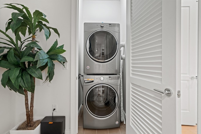 clothes washing area featuring stacked washer and dryer