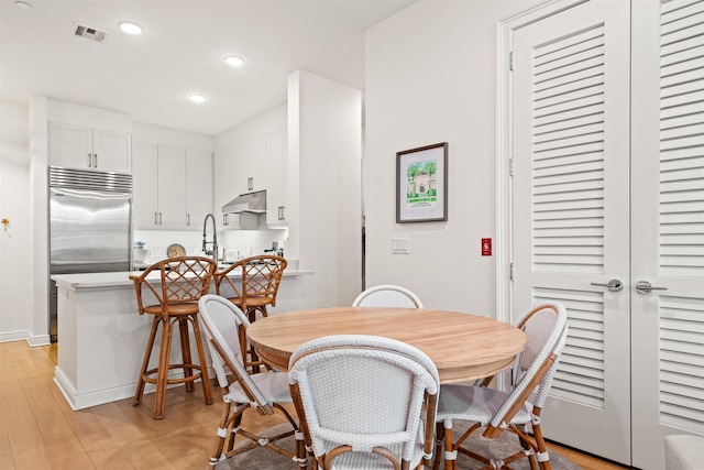 dining space with light hardwood / wood-style floors