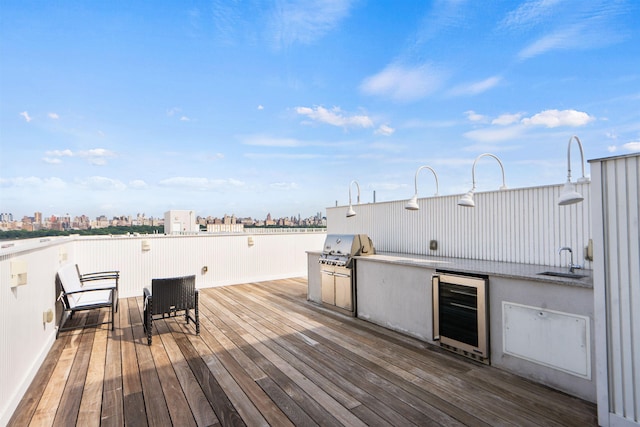 deck with a grill, area for grilling, sink, and wine cooler