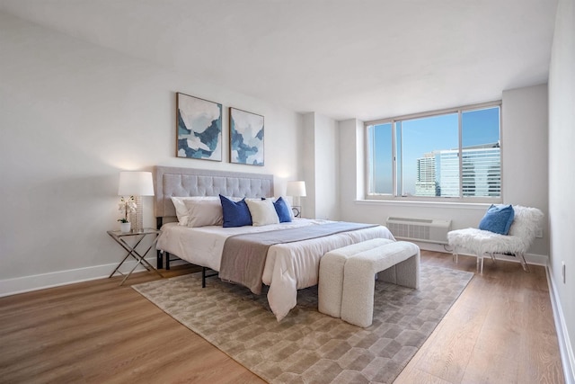 1 2nd St Unit 1012, Jersey City, NJ 07302 - bedroom with wood finished floors and a wall mounted air conditioner