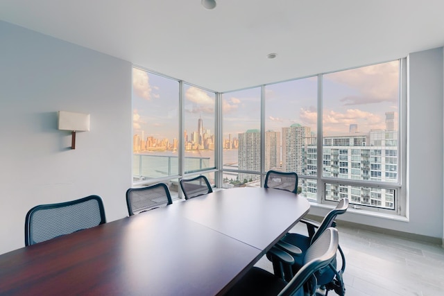 dining area with a view of city and wood finished floors