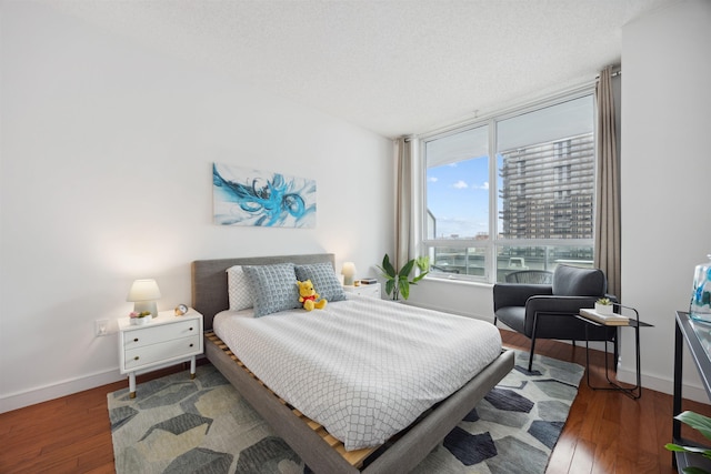 bedroom with wood finished floors and baseboards