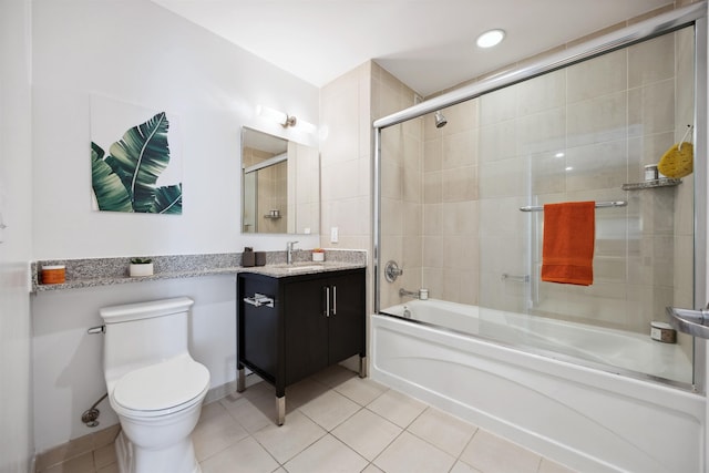 full bathroom with toilet, tile patterned floors, vanity, and bath / shower combo with glass door