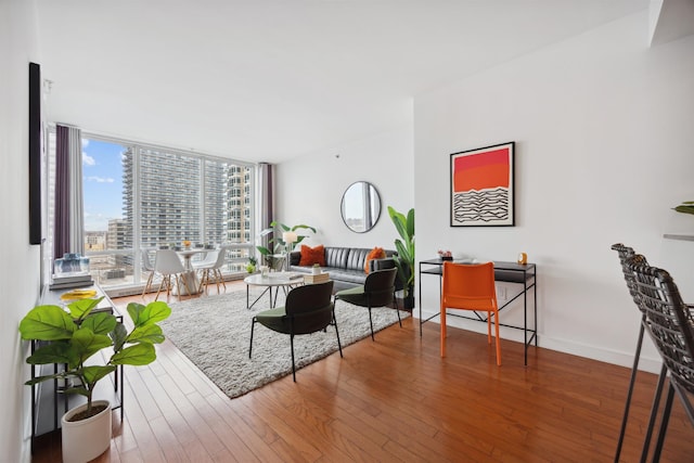 living area with a view of city and wood finished floors
