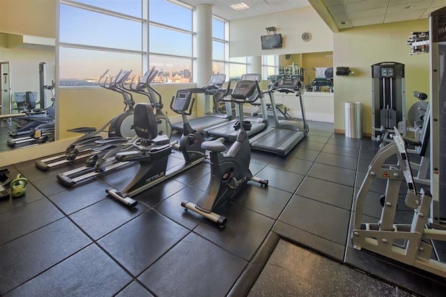workout area with baseboards and a drop ceiling
