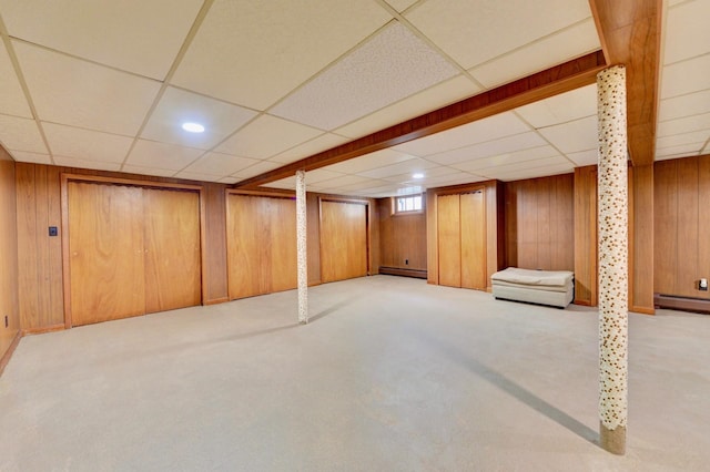 76 Central Ave, Secaucus, NJ 07094 - basement featuring a drop ceiling, a baseboard radiator, wooden walls, baseboard heating, and carpet floors