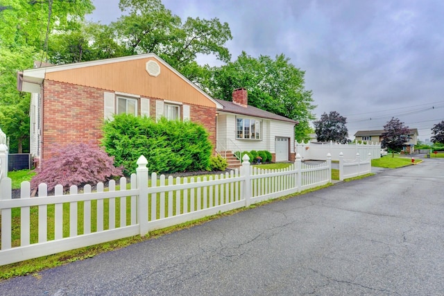 76 Central Ave, Secaucus, NJ 07094 - ranch-style house with brick siding, a fenced front yard, a chimney, and a garage
