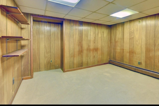 76 Central Ave, Secaucus, NJ 07094 - carpeted empty room featuring wooden walls, a paneled ceiling, and a baseboard radiator