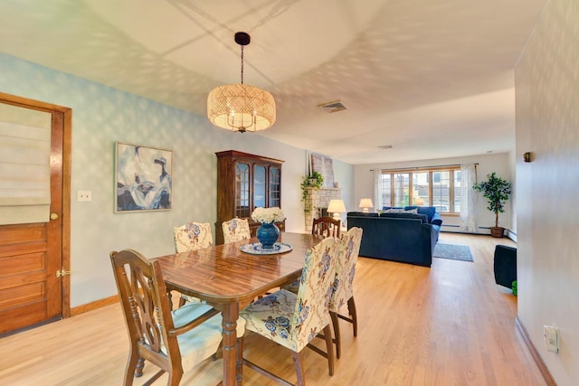 76 Central Ave, Secaucus, NJ 07094 - dining room featuring light wood finished floors, wallpapered walls, a chandelier, and baseboard heating