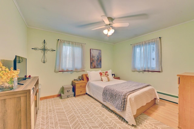 76 Central Ave, Secaucus, NJ 07094 - bedroom with a baseboard radiator, multiple windows, crown molding, a ceiling fan, and wood finished floors