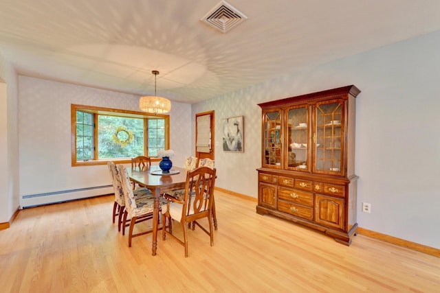 76 Central Ave, Secaucus, NJ 07094 - dining room with baseboard heating, light wood-type flooring, wallpapered walls, and a chandelier