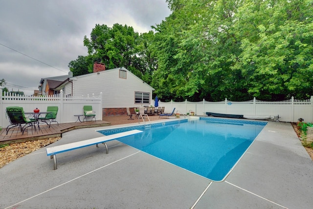 76 Central Ave, Secaucus, NJ 07094 - view of swimming pool featuring a diving board, a fenced backyard, a wooden deck, and a patio