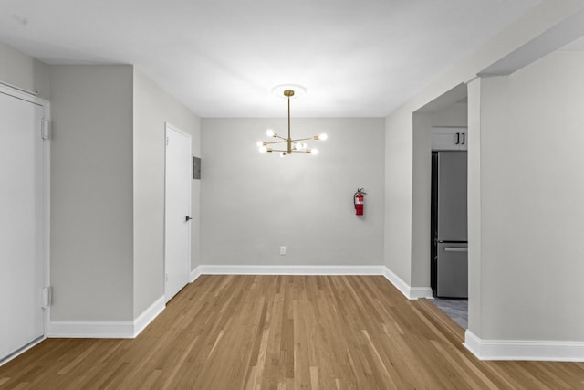 154 Bowers St Unit 2A, Jersey City, NJ 07307 - unfurnished dining area featuring light wood finished floors and a chandelier
