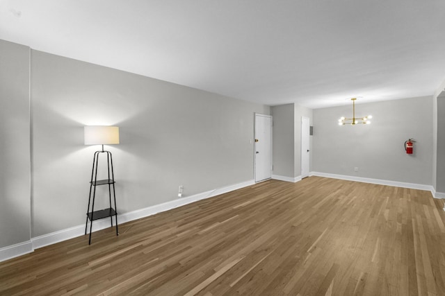154 Bowers St Unit 2A, Jersey City, NJ 07307 - unfurnished room featuring a chandelier and wood finished floors