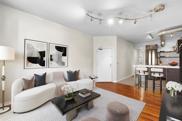 68 Park Ave Unit 3, Hoboken, NJ 07030 - living room featuring light wood finished floors and rail lighting