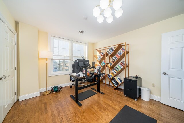 45 Broadway Unit 302, Jersey City, NJ 07306 - exercise room featuring wood finished floors and a chandelier