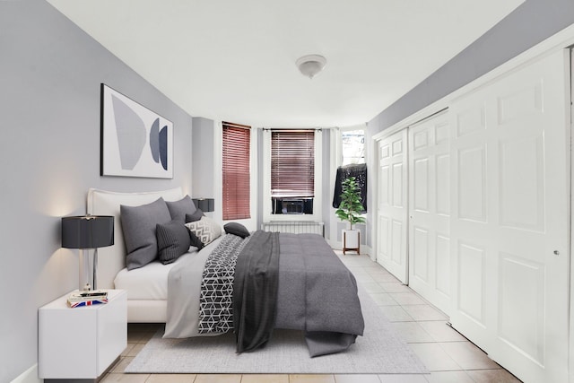 tiled bedroom with a closet