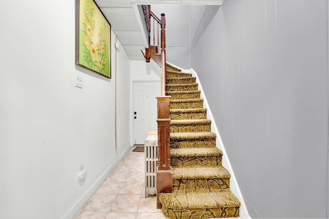 stairway with tile patterned floors