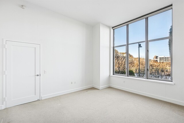 empty room featuring carpet floors and baseboards