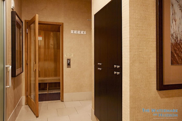 hall with tile patterned floors