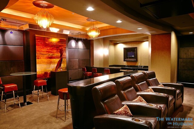 cinema with a community bar, a raised ceiling, carpet flooring, and recessed lighting