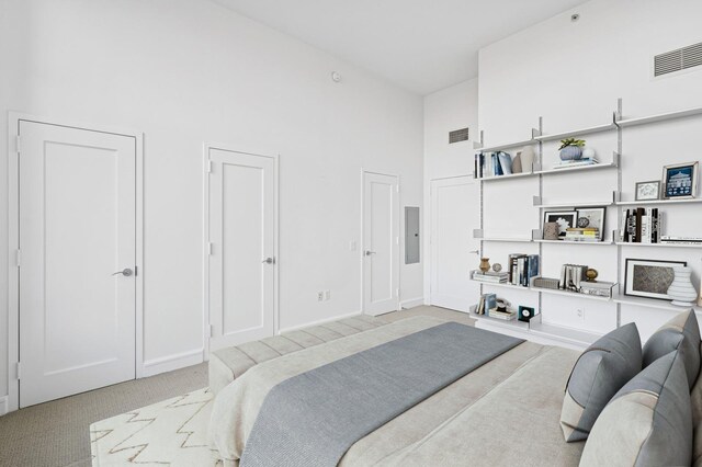 bedroom with high vaulted ceiling, electric panel, carpet flooring, and visible vents