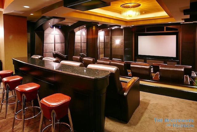 cinema with a raised ceiling and recessed lighting