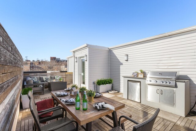 wooden deck with outdoor lounge area, outdoor dining area, exterior kitchen, and a grill
