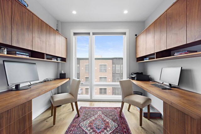office space with built in desk, light wood finished floors, recessed lighting, and baseboards