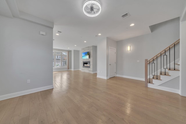 unfurnished living room featuring a fireplace and light wood-type flooring