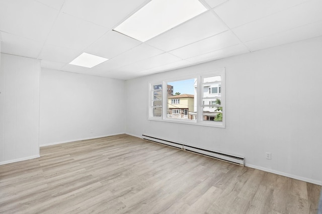 80 E 24th St, Bayonne, NJ 07002 - unfurnished room with a baseboard heating unit, wood finished floors, a drop ceiling, and baseboards
