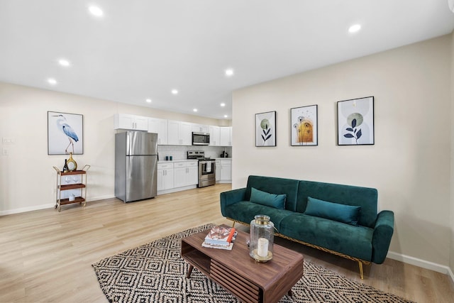 80 E 24th St, Bayonne, NJ 07002 - living room featuring light wood-type flooring, recessed lighting, and baseboards