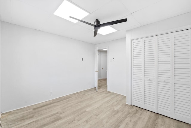 80 E 24th St, Bayonne, NJ 07002 - unfurnished bedroom with light wood-style flooring, ceiling fan, and a closet