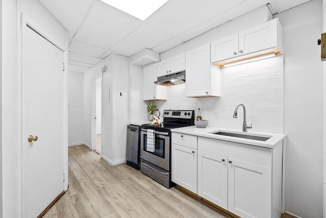 80 E 24th St, Bayonne, NJ 07002 - kitchen featuring stainless steel range with electric cooktop, under cabinet range hood, a sink, light wood-style flooring, and decorative backsplash
