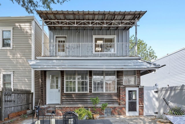 80 E 24th St, Bayonne, NJ 07002 - view of front of home featuring a balcony, board and batten siding, and a patio
