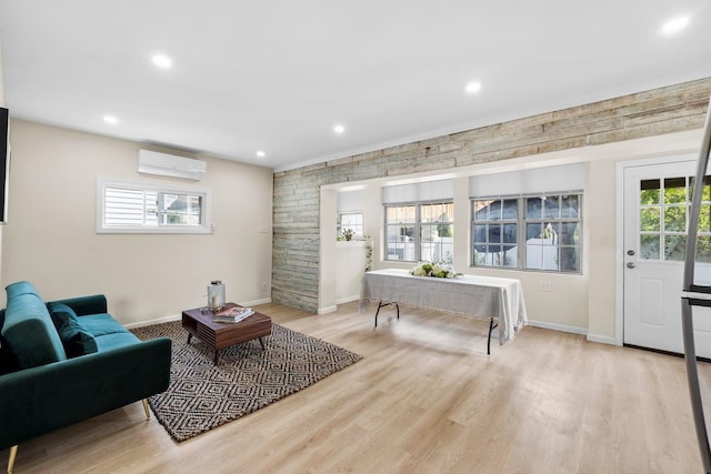 80 E 24th St, Bayonne, NJ 07002 - living area featuring a wall unit AC, light wood-style floors, recessed lighting, healthy amount of natural light, and baseboards