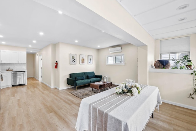 80 E 24th St, Bayonne, NJ 07002 - dining space featuring a wall unit AC, baseboards, light wood-style floors, and recessed lighting