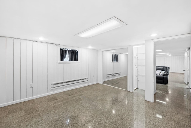 80 E 24th St, Bayonne, NJ 07002 - finished below grade area featuring baseboard heating, granite floors, recessed lighting, baseboards, and a decorative wall
