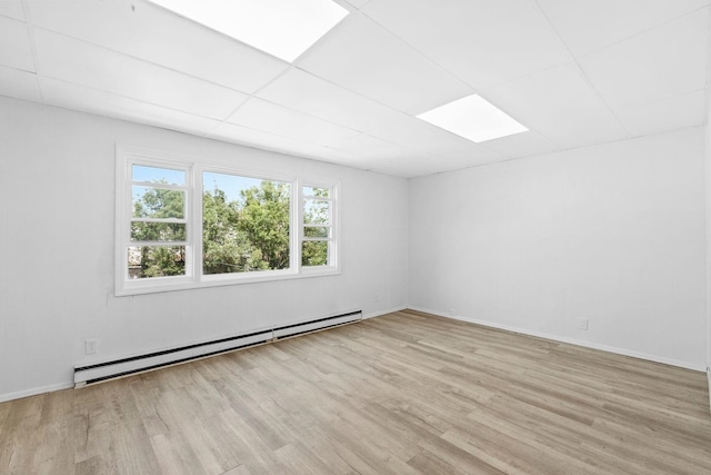 80 E 24th St, Bayonne, NJ 07002 - empty room with baseboard heating, light wood-style floors, plenty of natural light, and baseboards