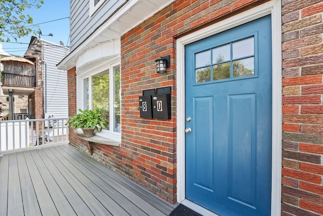 80 E 24th St, Bayonne, NJ 07002 - doorway to property with brick siding and a porch