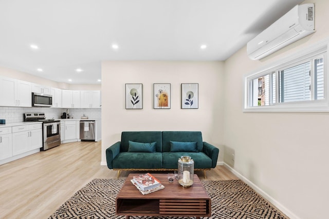 80 E 24th St, Bayonne, NJ 07002 - living room featuring a wall mounted air conditioner, light wood-style flooring, baseboards, and recessed lighting