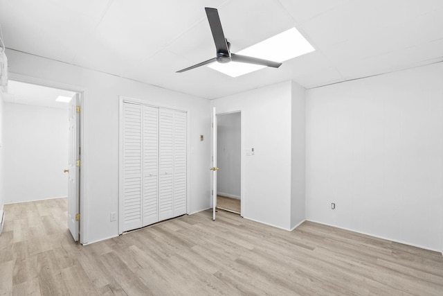80 E 24th St, Bayonne, NJ 07002 - unfurnished bedroom with light wood-type flooring, a ceiling fan, and a closet