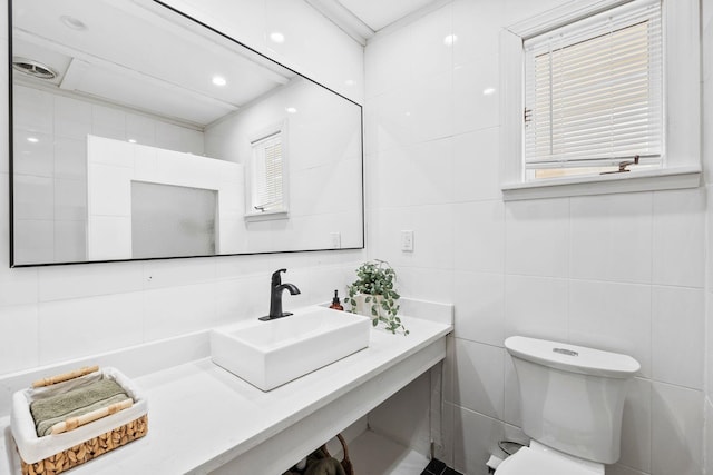 80 E 24th St, Bayonne, NJ 07002 - bathroom featuring tile walls, toilet, vanity, and backsplash