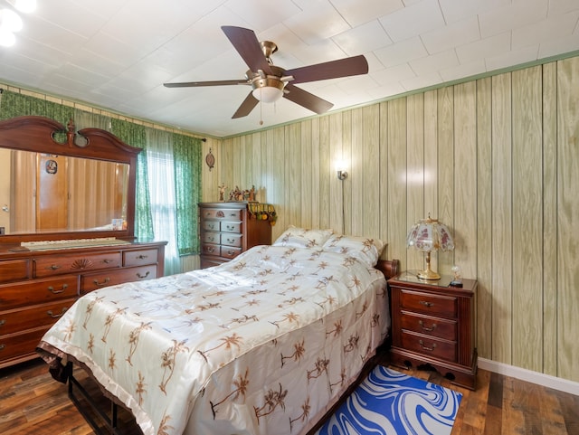 bedroom featuring ceiling fan, baseboards, and wood finished floors